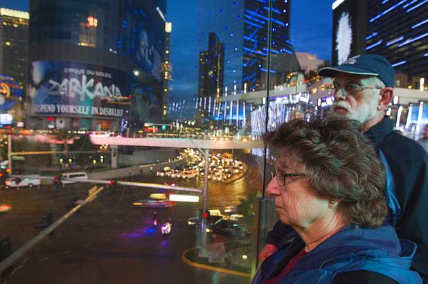 Ira and Linda Langston of Champaigne, Ill. wait for a parade of NASCAR haulers on the Las Vegas Strip Wednesday, March 6, 2013.  The NASCAR hauler parade traveled north on the Las Vegas Strip to Sahara Avenue, then on I-15 to the Las Vegas Motor Speedway.