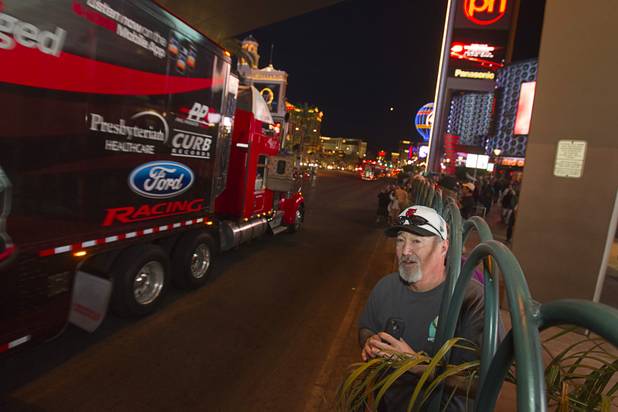 Tony Gaitero of Sacrament, Calif. watches a parade of NASCAR haulers on the Las Vegas Strip Wednesday, March 6, 2013.  The NASCAR hauler parade traveled north on the Las Vegas Strip to Sahara Avenue, then on I-15 to the Las Vegas Motor Speedway.