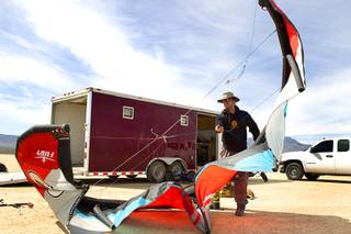 Brian Holgate, 28, prepares a kite for his specially-designed Peter Lynn kite buggy on the Ivanpah dry lake bed near Primm, Nev. Wednesday, March 6, 2013. Holgate set an unofficial kite buggy speed record of 84.4 mph at the lake bed in July 2012.