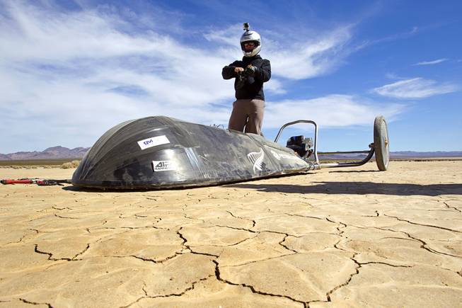 Brian Holgate, 28, prepares for a run in a specially-designed Peter Lynn kite buggy on the Ivanpah dry lake bed near Primm, Nev. Wednesday, March 6, 2013. Holgate set an unofficial kite buggy speed record of 84.4 mph at the lake bed in July 2012.