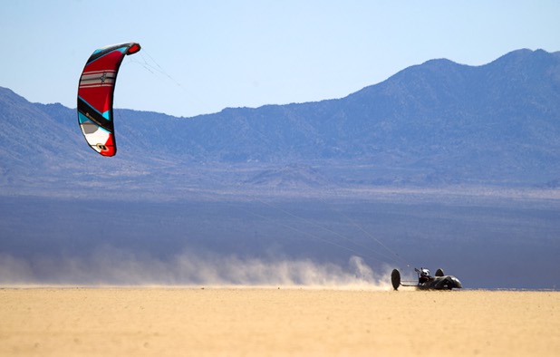 Brian Holgate, 28, runs across the Ivanpah dry lake bed in a specially-designed Peter Lynn kite buggy near Primm, Nev. Wednesday, March 6, 2013. Holgate set an unofficial kite buggy speed record of 84.4 mph at the lake bed in July 2012.