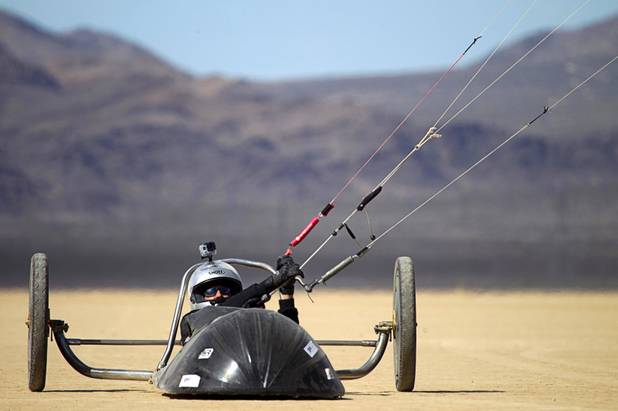 Brian Holgate, 28, finishes a run in a specially-designed Peter Lynn kite buggy on the Ivanpah dry lake bed near Primm, Nev. Wednesday, March 6, 2013. Holgate set an unofficial kite buggy speed record of 84.4 mph at the lake bed in July 2012.