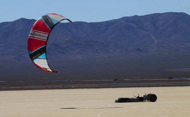 Brian Holgate, 28, runs in a specially-designed Peter Lynn kite buggy on the Ivanpah dry lake bed near Primm, Nev. Wednesday, March 6, 2013. Holgate set an unofficial kite buggy speed record of 84.4 mph at the lake bed in July 2012.