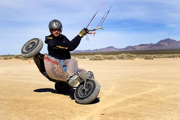 Brian Holgate, 28, rides in a free-style kite buggy on the Ivanpah dry lake bed near Primm, Nev. Wednesday, March 6, 2013. Holgate set an unofficial kite buggy speed record of 84.4 mph at the lake bed in July 2012.