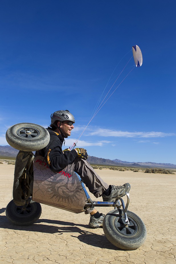 Brian Holgate, 28, rides in a free-style kite buggy on the Ivanpah dry lake bed near Primm, Nev. Wednesday, March 6, 2013. Holgate set an unofficial kite buggy speed record of 84.4 mph at the lake bed in July 2012.