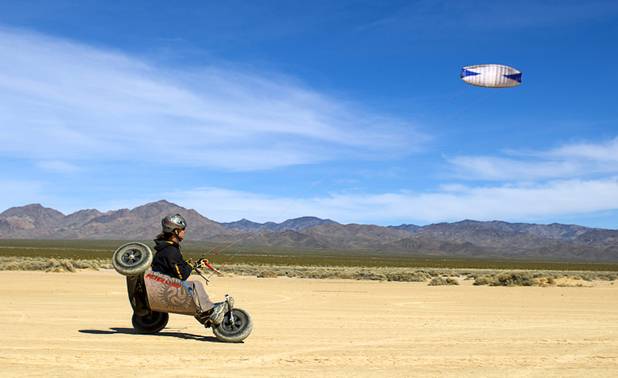 Brian Holgate, 28, rides in a free-style kite buggy on the Ivanpah dry lake bed near Primm, Nev. Wednesday, March 6, 2013. Holgate set an unofficial kite buggy speed record of 84.4 mph at the lake bed in July 2012.