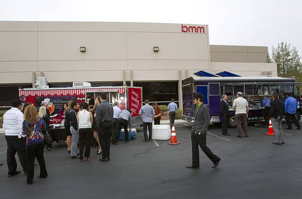 Employees and invited guests get lunch at catered food trucks during the opening of the BMM Testlabs new world headquarters in Las Vegas Thursday, March 7, 2013. BMM employs more than 200 people in 12 countries and operates 11 gaming labs, serving more than 400 gaming jurisdictions.