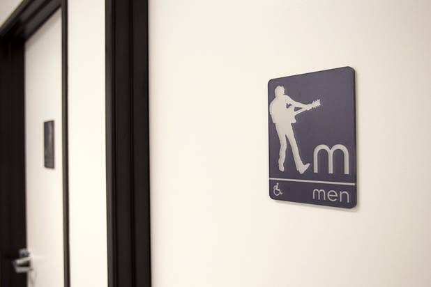 Even the restroom signs reflect the company's rock 'n roll theme at the BMM Testlabs new world headquarters in Las Vegas Thursday, March 7, 2013. BMM employs more than 200 people in 12 countries and operates 11 gaming labs, serving more than 400 gaming jurisdictions.