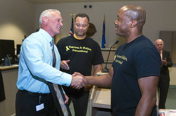 Judge Mark Stevens, left, shakes hands with Andre Haynes of Veterans in Politics International, after the group endorsed him during Veterans Court in Henderson Thursday, March 7, 2013. Veterans in Politics president Steve Sanson looks on at center.