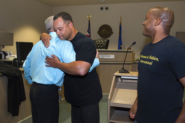 Judge Mark Stevens, left, gets a hug from Steve Sanson of Veterans in Politics International, after the group endorsed the judge during Veterans Court in Henderson Thursday, March 7, 2013. Veterans in Politics menber Andre Haynes is at right.