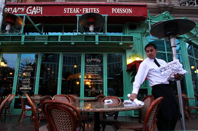 Shortly after 6am, Javier Hernandez sets a table at Mon Ami Gabi on the Strip Friday, March 8, 2013.