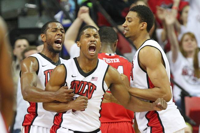 UNLV's Mike Moser, Justin Hawkins and Khem Birch celebrate Hawkins basket and drawing a foul on Fresno State during their final regular season game Saturday, March 9, 2013 at the Thomas & Mack Center.