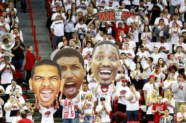UNLV fans hold up giant cutouts of senior players Anthony Marshall, Justin Hawkins and Quintrell Thomas before their game against Fresno State on Saturday, March 9, 2013, at the Thomas & Mack Center.