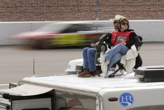 NASCAR fans watch from the tops of their recreational vehicles during practice for the NASCAR Sprint Cup Series race, Saturday, March 9, 2013, in Las Vegas. (AP Photo/Julie Jacobson)