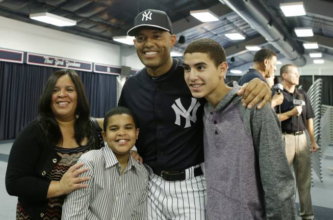 New York Yankees pitcher Mariano Rivera, who holds baseball's all-time saves record, poses for a photograph with his wife, Clara, and sons Jaziel, left, and Jafet, right, after announcing his plans to retire at the end of the 2013 season during a news conference at Steinbrenner Field on Saturday, March 9, 2013 in Tampa, Fla.