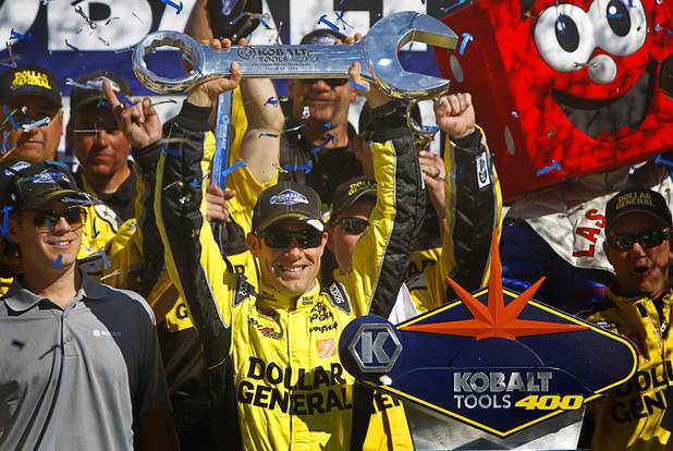 Matt Kenseth holds up his trophy in Victory Lane after winning the Kobalt Tools 400 at Las Vegas Motor Speedway on Sunday, March 10, 2013.
