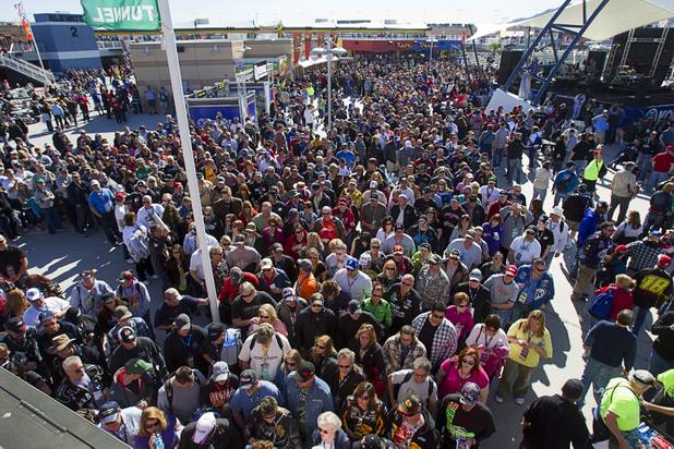 Fans head to the grandstands from the Neon Garage prior to the start of the Kobalt Tools 400 NASCAR race at the Las Vegas Motor Speedway Sunday, March 10, 2013.