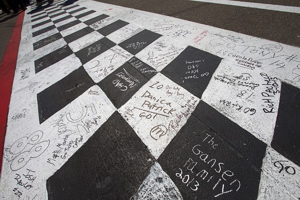 Messages are shown on the finish line before the start of the Kobalt Tools 400 NASCAR race at the Las Vegas Motor Speedway Sunday, March 10, 2013.