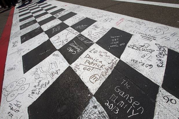 Messages are shown on the finish line before the start of the Kobalt Tools 400 NASCAR race at the Las Vegas Motor Speedway Sunday, March 10, 2013.