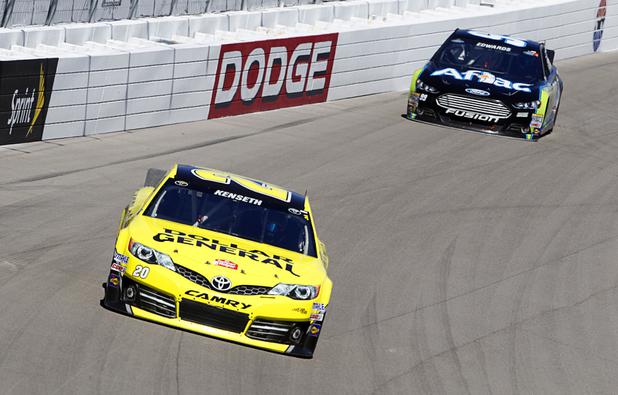 Matt Kenseth (20), left, leads Carl Edwards (99) during the Kobalt Tools 400 NASCAR race at the Las Vegas Motor Speedway Sunday, March 10, 2013. Kenseth won the race.