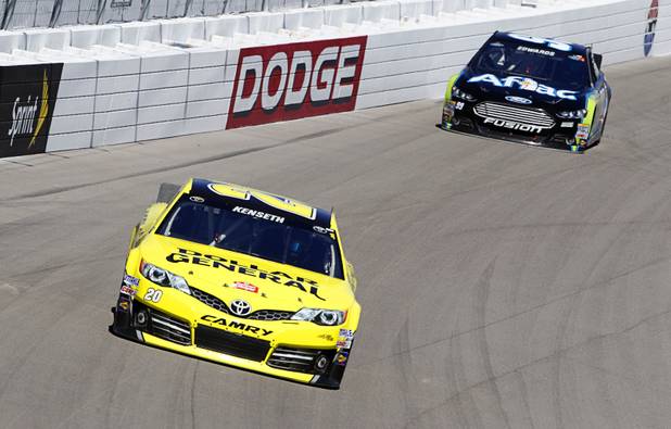 Matt Kenseth (20), left, leads Carl Edwards (99) during the Kobalt Tools 400 NASCAR race at the Las Vegas Motor Speedway Sunday, March 10, 2013. Kenseth won the race.