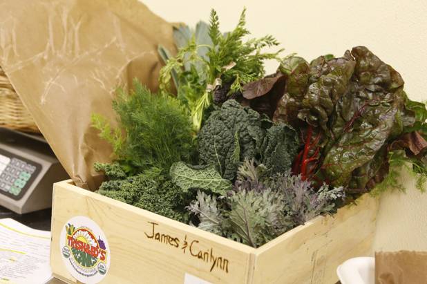 A wooden crate with fresh fruit and vegetables is shown at Trish & Ed's Organics, Wednesday, March 6, 2013.