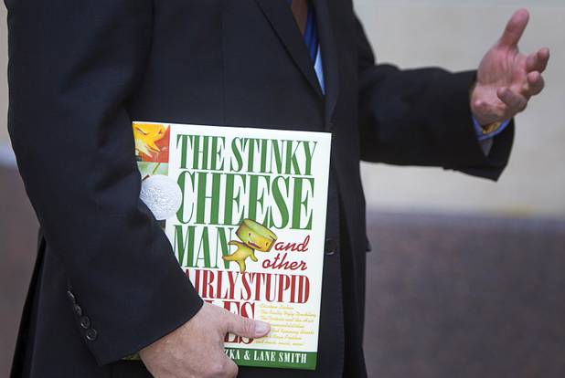 Myron Martin, president and CEO of the Smith Center, holds a copy of "The Stinky Cheese Man and other Fairly Stupid Tales" before a performance at the Smith Center for the Performing Arts Tuesday, March 12, 2013. As part of the Smith Center's mission combining performing arts and education, and in partnership with the Clark County School District, the center hosted more than 1,500 elementary school students from Southern Nevada for the special performance of The Stinky Cheese Man by members of the Griffin Theater of Chicago.