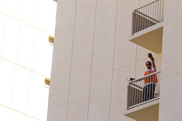 A worker waves from a hotel tower during a tour of work on the SLS Las Vegas resort, formerly the Sahara, Wednesday, March 13, 2013. The renovated resort is expected to open in the fall of 2014.