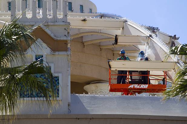 Workers demolish the old porte cochere at the SLS Las Vegas resort, formerly the Sahara, Wednesday, March 13, 2013. The renovated resort is expected to open in the fall of 2014.
