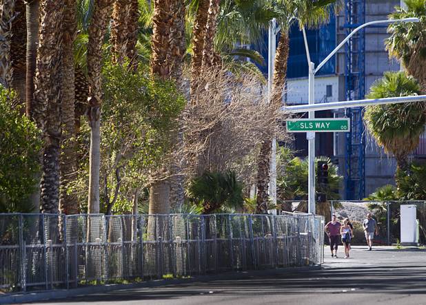 Pedestrians pass by SLS Way outside the SLS Las Vegas resort, formerly the Sahara, Wednesday, March 13, 2013. The renovated resort is expected to open in the fall of 2014.