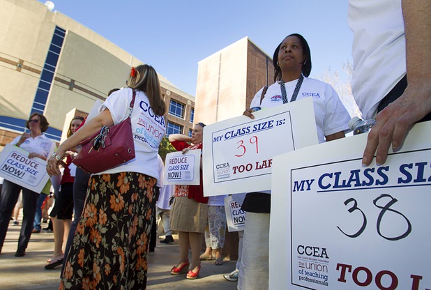Nicole Thompson, right, an English teacher at Desert Pines High School, waits for a rally outside the Sawyer State Building Wednesday, March 13, 2013. Teachers, parents and union members held the rally as legislators were meeting in a joint assembly and senate committee meeting to discuss education issues.