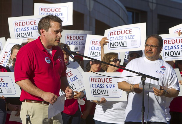 Shawn Bolin, a fifth grade teacher at Hickey Elementary School, speaks during a news conference outside the Sawyer State Building Wednesday, March 13, 2013. Ruben Murillo Jr., Clark County Education Association president, listens at right. Teachers, parents and union members held the rally as legislators were meeting in a joint assembly and senate committee meeting to discuss education issues.