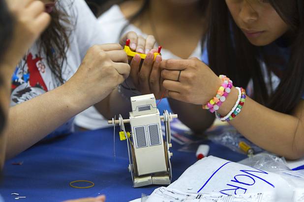 Students assemble a robot from a kit during the annual HerWorld workshop at the Henderson Convention Center Thursday, March 14, 2013. About 230 students attended the workshop, sponsored by DeVry University, intended to introduce female high school students to careers in science, technology, engineering and math.