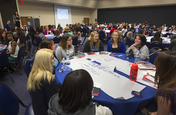 A team of students present ideas on how to deal with global warming during the annual HerWorld workshop at the Henderson Convention Center Thursday, March 14, 2013. About 230 students attended the workshop, sponsored by DeVry University, intended to introduce female high school students to careers in science, technology, engineering and math.