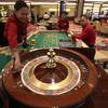 Casino dealers work on their respective games during a media tour of the new Solaire Casino, one of the country's  biggest casinos, Thursday  March 14, 2013, at suburban Pasay city south of Manila, Philippines.