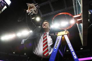 New Mexico head coach Steve Alford finishes cutting down the net after the Lobos defeated UNLV 63-56 to win the Mountain West Conference Tournament championship game Saturday, March 16, 2013 at the Thomas & Mack Center. 
