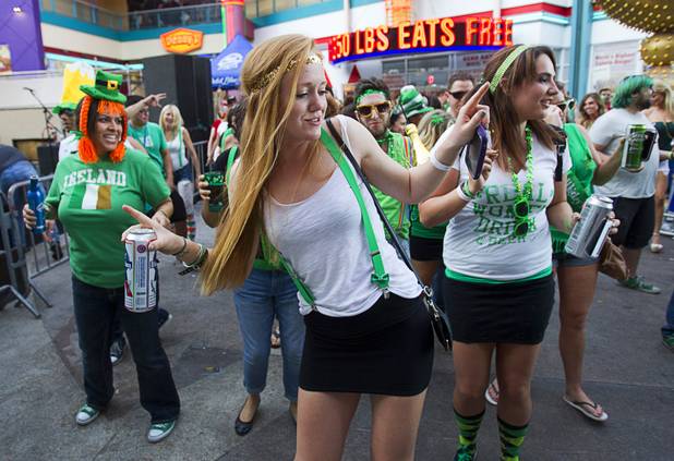 Partiers dance outside Hennessey's Tavern on Fremont Street during St. Patrick's Day Sunday, March 17, 2013.