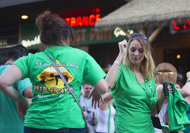 Partiers dance outside Hennessey's Tavern on Fremont Street during St. Patrick's Day Sunday, March 17, 2013.