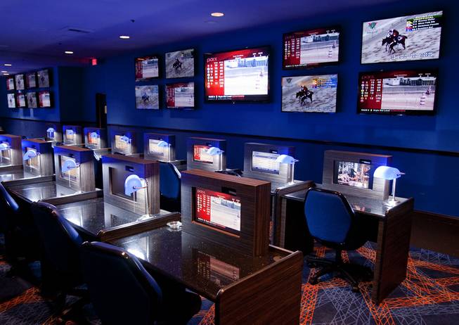 Seventeen state-of-the-art monitors illuminate one wall of the William Hill Race & Sports Book inside the Plaza Hotel, with dozens more mounted in seated stations, March 19, 2013.