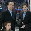 Former Las Vegas Wranglers goaltender Marc Magliarditi, left, his son and Wranglers General Manager Billy Johnson after being presented a plaque in recognition of his induction into the ECHL Hall of Fame in January 2013.