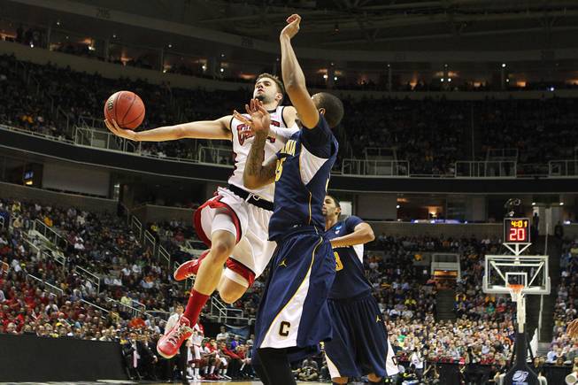 UNLV guard Katin Reinhardt is defended by Cal forward Richard Solomon during their second round game at the NCAA Basketball Tournament Thursday, March 21, 2013 at the HP Pavilion in San Jose, Calif. UNLV lost to Cal 64-61 to exit the tournament after one game for the fourth year in a row.
