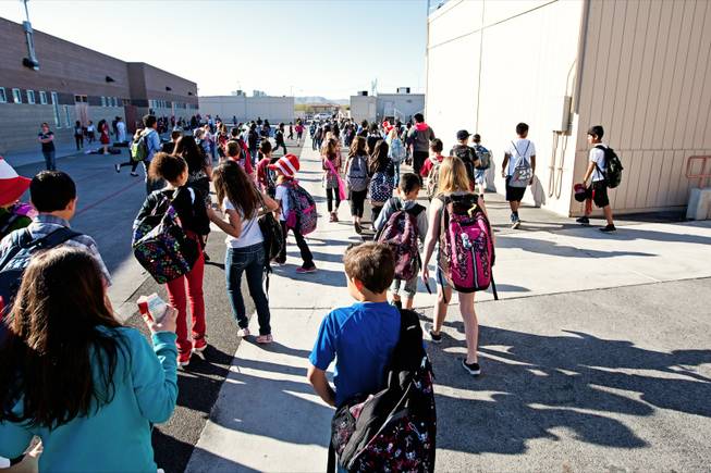 Hundreds of students flood the playground to start their day at the overcrowded, with an enrollment of 1240 students, and also the largest elementary school in Las Vegas, William V. Wright Elementary, Friday, March 22, 2013. 