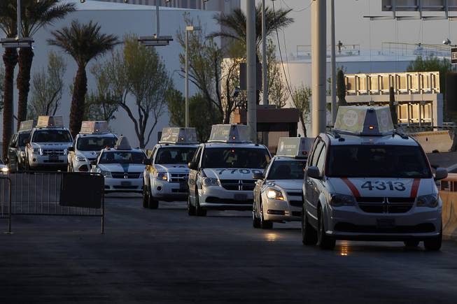 Taxis are seen queued up at McCarran International Airport on Friday, March 22, 2013.