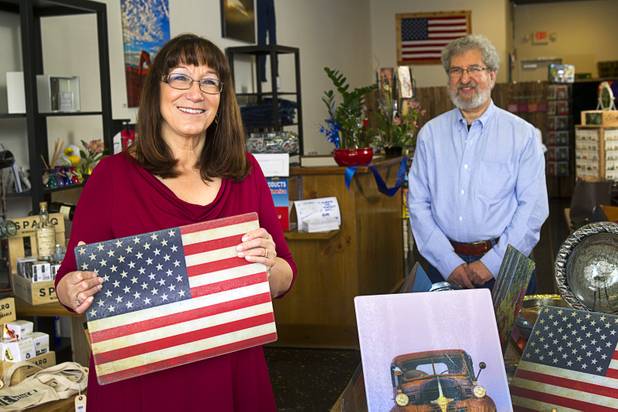 Ava and Richard Naft pose in USA Boutiques, 9500 S. Eastern Ave., Monday, March 25, 2013. The store sells only made-in-the-USA products. Ava is holding a cutting board.