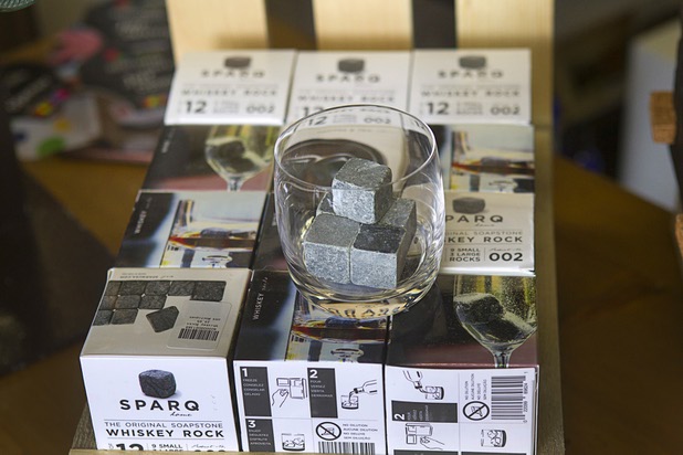 Sparq whiskey rocks are displayed at USA Boutiques, 9500 S. Eastern Ave., Monday, March 25, 2013. The soapstone rocks are stored in the freezer and used as a replacement for ice cubes. They keep the drinks cold without diluting them. The store sells only made-in-the-USA products.