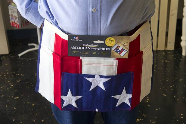 Richard Naft models an apron at USA Boutiques, 9500 S. Eastern Ave., Monday, March 25, 2013. The store sells only made-in-the-USA products.