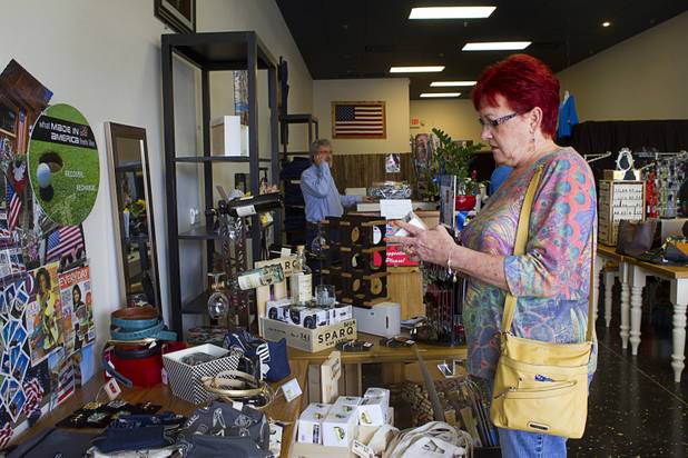 Floreen Clark looks over items at USA Boutiques, 9500 S. Eastern Ave., Monday, March 25, 2013. The store sells only made-in-the-USA products.