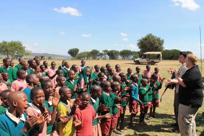Children at Oloibormurt Primary School in the Maasai Mara region of southeast Kenya sing with Frankie Moreno and his brothers Ricky and Tony.
