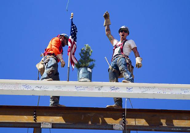 Ironworker Mike Dyke, right, celebrates after securing the final steel beam with Jeff Koch during a topping-out ceremony for the Federal Justice Tower in downtown Las Vegas Wednesday, March 27, 2013. The new 11-story tower, just to the south of the Lloyd D. George Federal Courthouse on Las Vegas Boulevard, will house the executive and administrative offices of the Department of Homeland Security, U.S. Immigration, U.S. Attorney's Office for the District of Nevada, the Department of Labor Office of Inspector General and the Federal Protective Services.