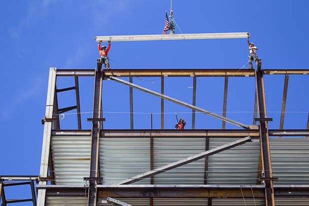 Ironworkers Jeff Koch, left, Mike Dyke secure the final steel beam during a topping-out ceremony for the Federal Justice Tower in downtown Las Vegas Wednesday, March 27, 2013. The new 11-story tower, just to the south of the Lloyd D. George Federal Courthouse on Las Vegas Boulevard, will house the executive and administrative offices of the Department of Homeland Security, U.S. Immigration, U.S. Attorney's Office for the District of Nevada, the Department of Labor Office of Inspector General and the Federal Protective Services.